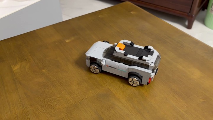 A LEGO model of a DiDi autonomous driving car, reconstructed in 3D from a 34-second video together with the surrounding tabletop and room.